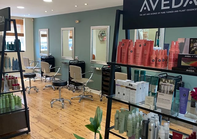 Styling chairs and product displays inside Head Hair & Beauty salon.
