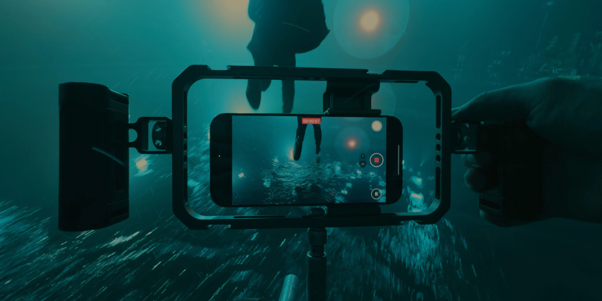 A photo taken from The Weeknd's 'Dancing In The Flames' behind the scenes video. In the photo, there is the iPhone 16 Pro filming the music video in camera mode.