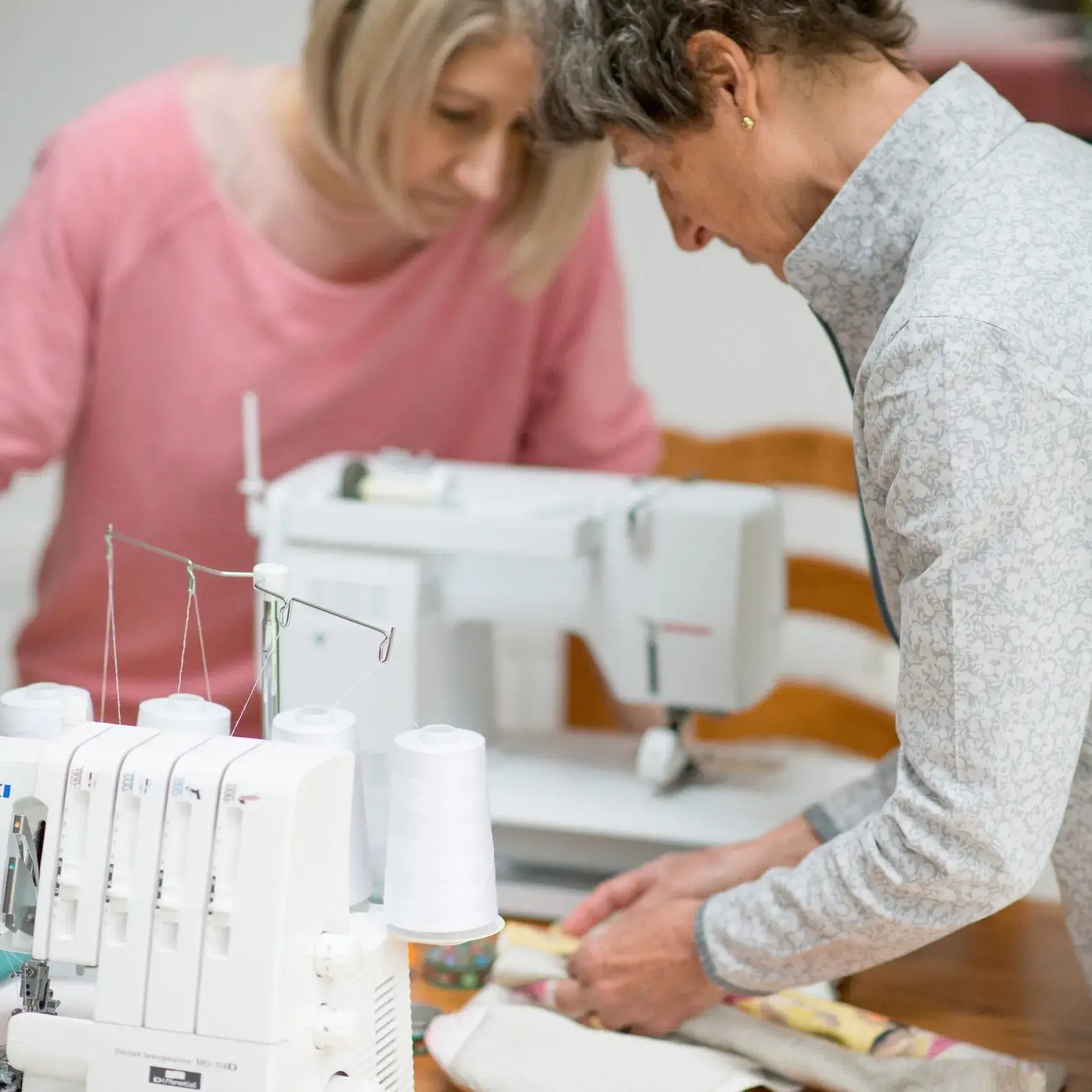 Equilibrium Lifestyle is a client of LoudLocal. This image shows two people using a sewing machine to create equilibrium lifestyle products.