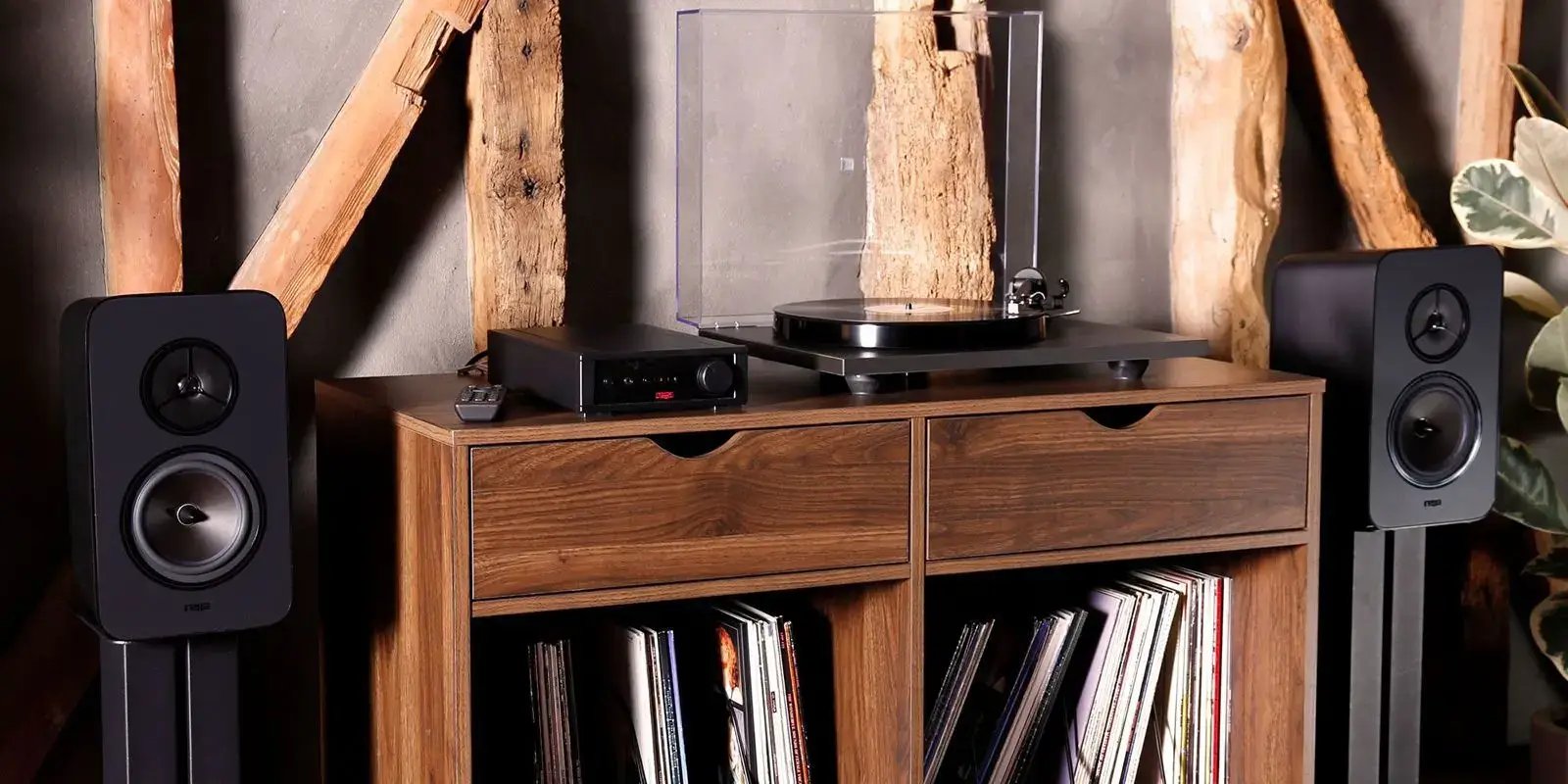 HiFix is a client of LoudLocal. This image shows a sound system and record player on a wooden set of drawers with a collection of records underneath and wooden beams in the background