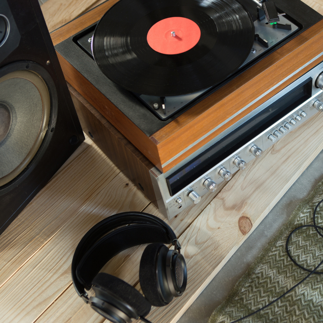 A record player with speaker and headphones next to it