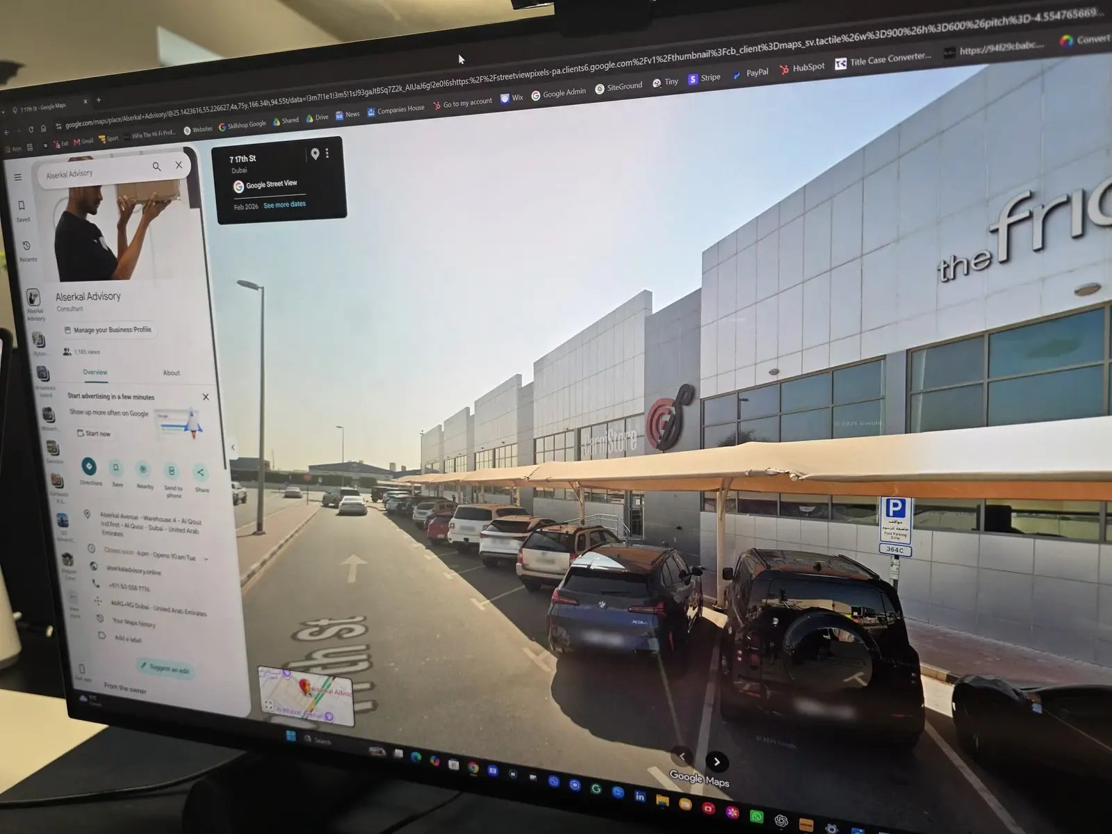 Alserkal Advisory's Google Maps listing beside a Street View scene of Alserkal Avenue in Dubai, displayed on a monitor.