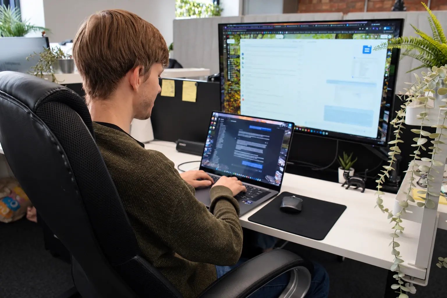Lyndon Barry using ChatGPT and AI editing tools at his desk.