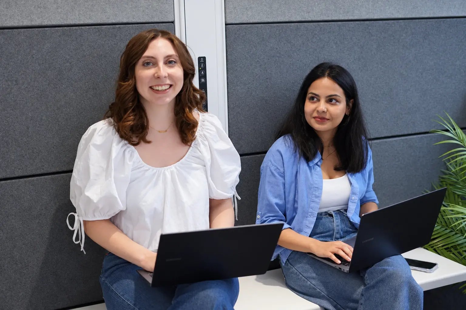 Mia Deeming and Siddhi Jain in a meeting with their laptops.