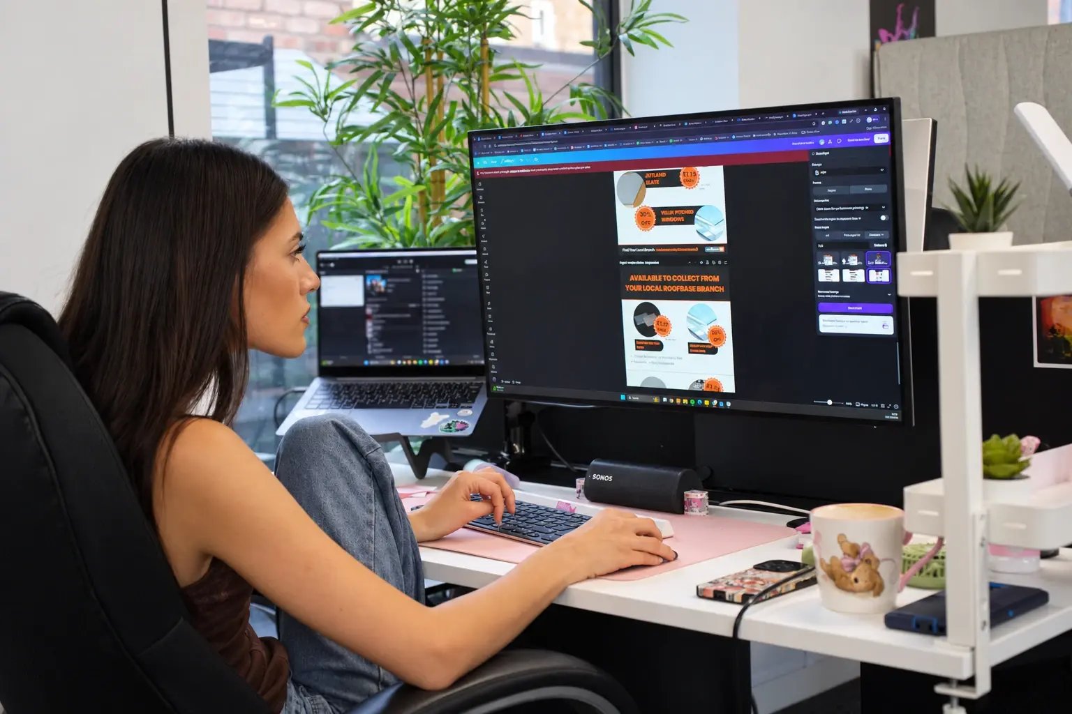 Tanya creating social media tiles for Roofbase in Canva.
