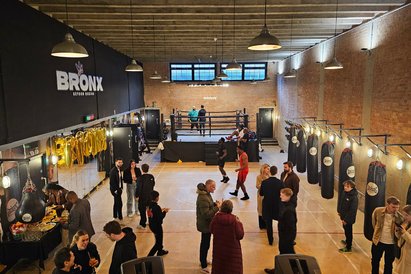 People gathering beside the boxing ring at Bronx Boxing.