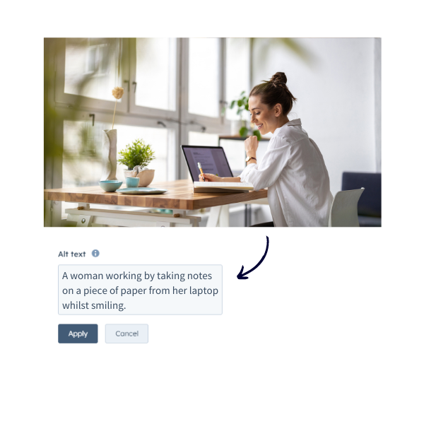 A woman working by taking notes on a piece of paper from her laptop whilst smiling.
