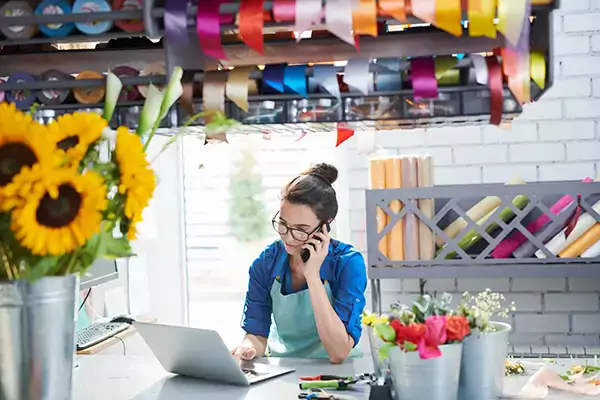 Florist using mobile phone