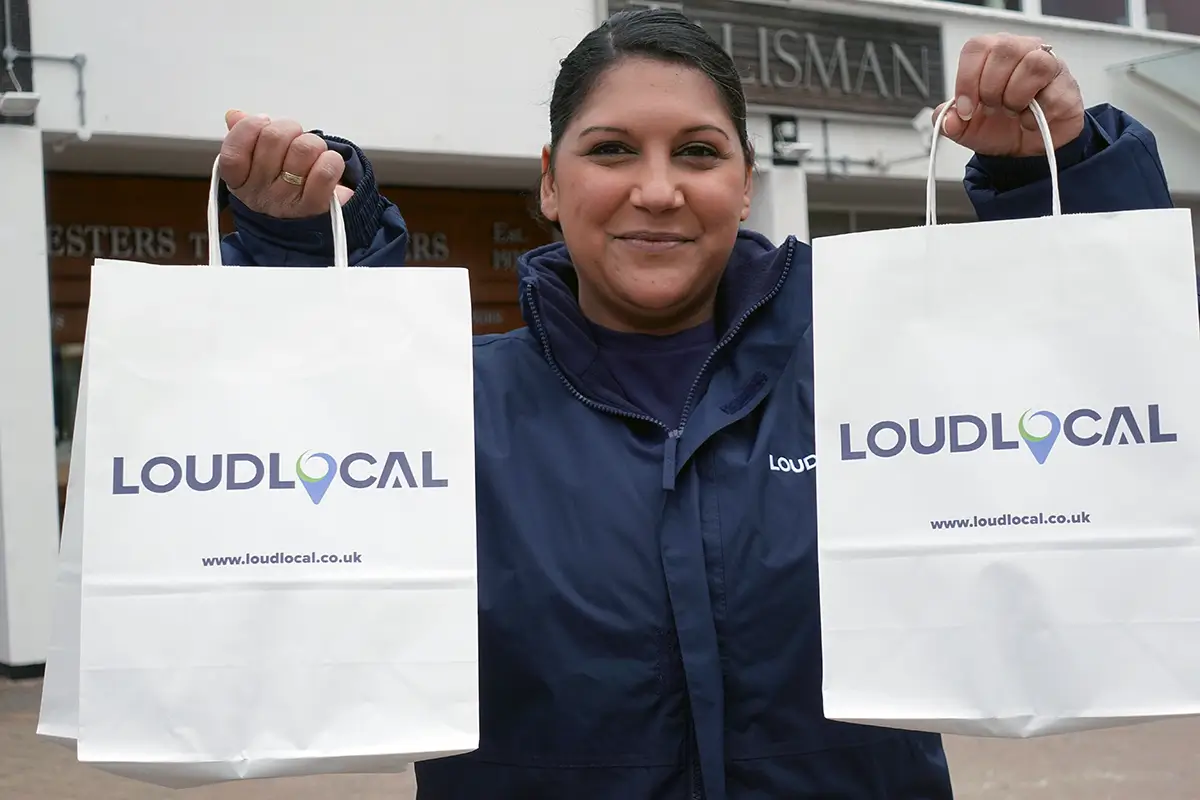 Priya handing out bags in Kenilworth to local businesses