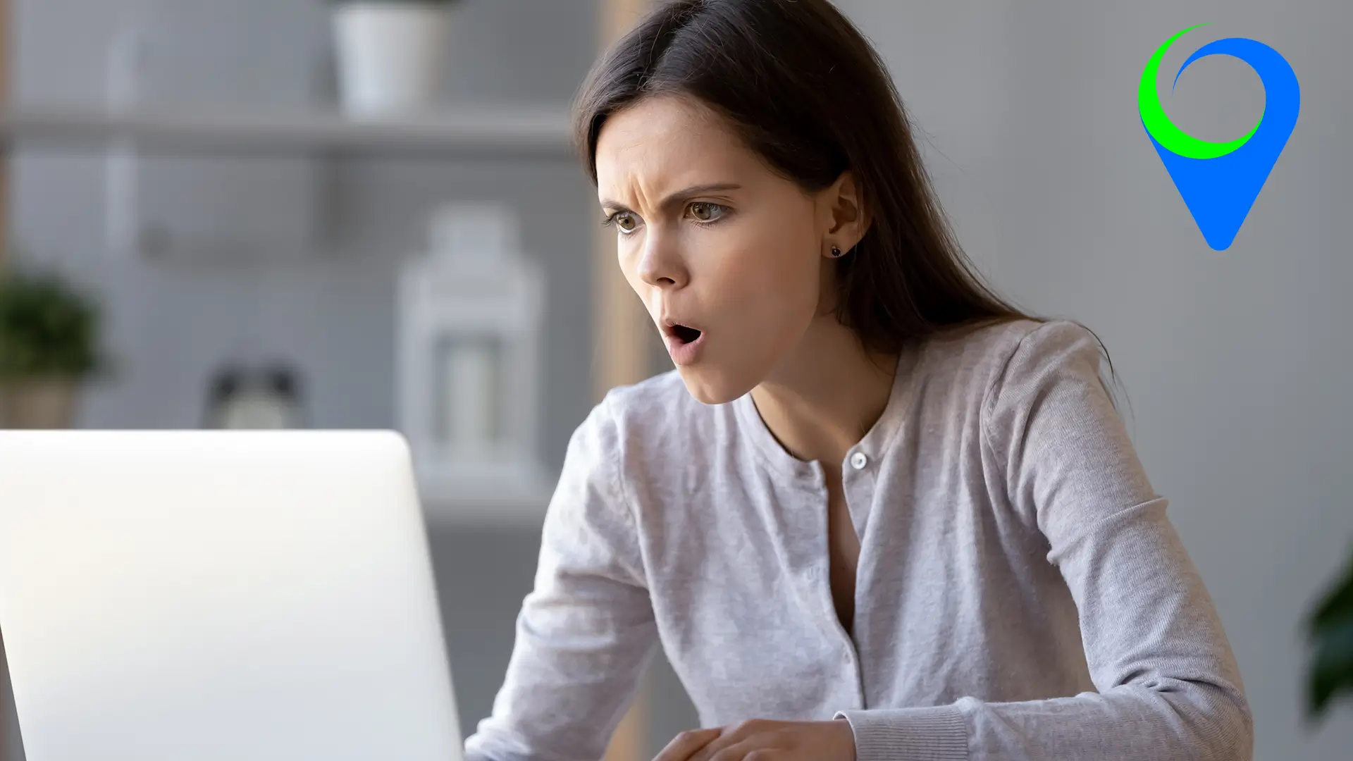 An image of someone looking frustrated whilst working at a laptop