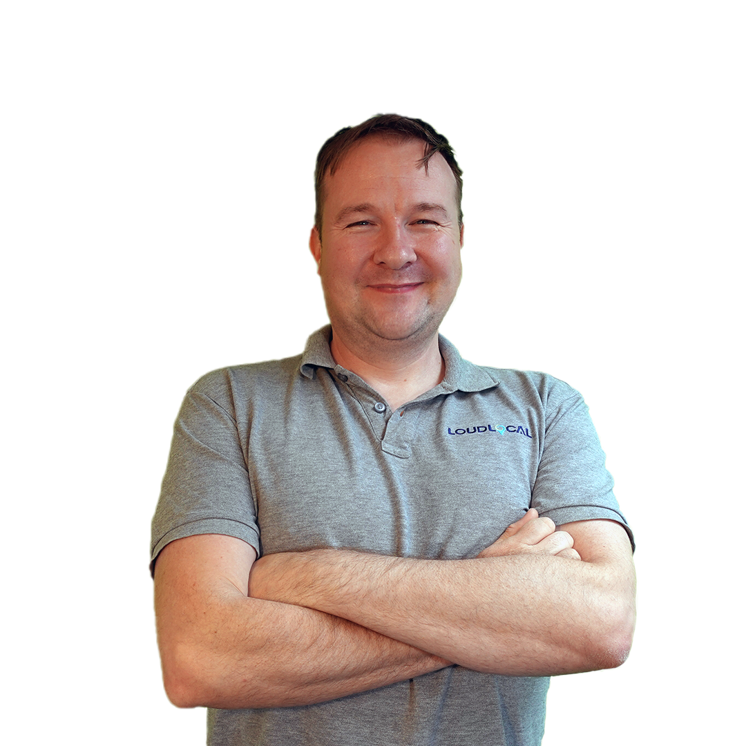 Leon Hidderley our Digital Marketing Director and Founder, wearing a grey loudlocal t-shirt and smiling.