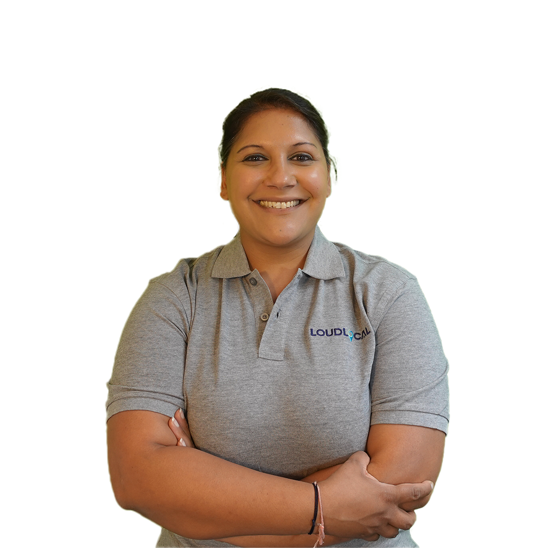 Priya Pandit Our commercial director, wearing a grey loudlocal polo shirt and smiling against a white background